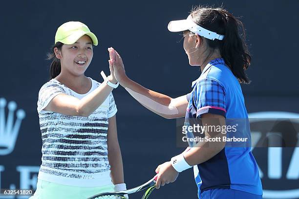 Pei Hsuan Chen of Taipei and Naho Sato of Japan compete in their second round match against Bianca Vanessa Andreescu of Canada and Carson Branstine...