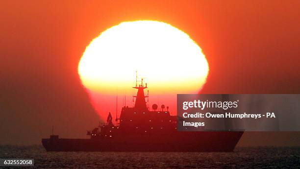 The HMS Severn patrol vessel sits out on the North Sea as the sun rises through the mist near Tynemouth.