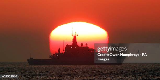 The HMS Severn patrol vessel sits out on the North Sea as the sun rises through the mist near Tynemouth.