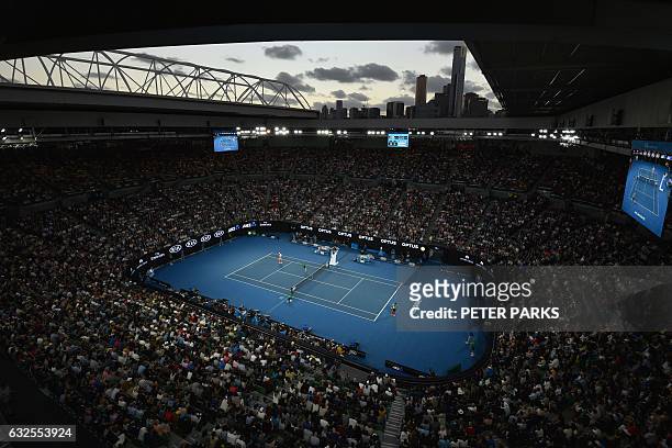 Spectators watch the men's singles quarter-final match between Switzerland's Roger Federer and Germany's Mischa Zverev on day nine of the Australian...