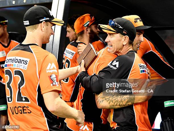 Justin Langer, coach of the Scorchers celebrates with his team after victory over the Stars during the Big Bash League match between the Perth...