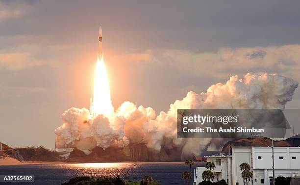 The H-IIA 32 rocket carrying the X-band communication satellite lifts off from the Japan Aerospace Exploration Agency 's Tanegashima Space Center on...