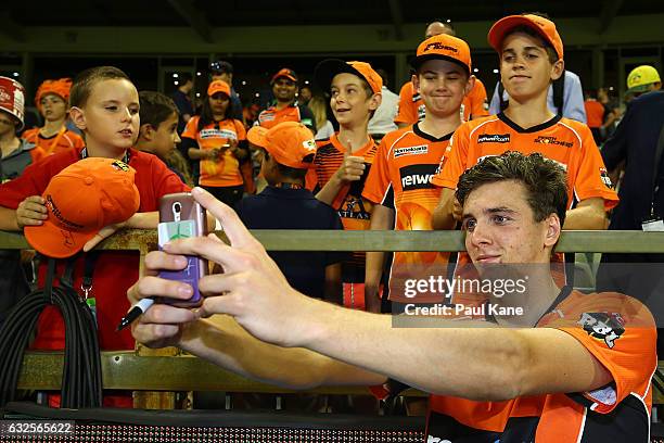 Jhye Richardson of the Scorchers poses for selfies with supporters after winning the Big Bash League match between the Perth Scorchers and the...