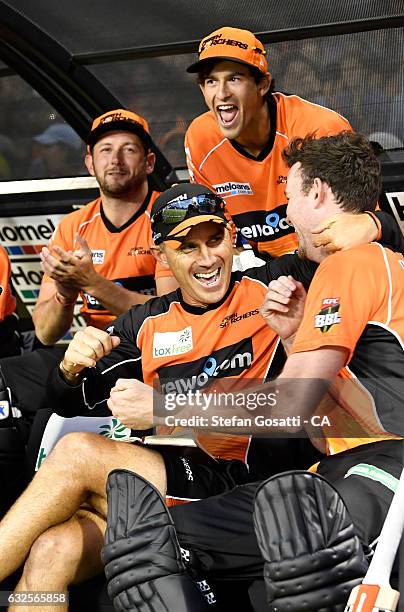 Justin Langer, coach of the Scorchers celebrates with his team after victory over the Stars during the Big Bash League match between the Perth...