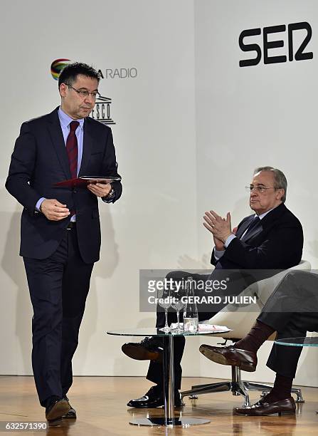 Barcelona President Josep Maria Bartomeu walks past Real Madrid President Florentino Perez during the presentation of a PRISA and UNESCO awarness...
