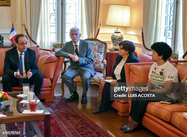 French President Francois Hollande speaks with relatives of victims of the Colombian armed conflict Gloria Gomez and Merleny Orjuela during a meeting...