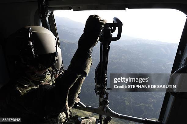 Soldier remains on a helicoper as it overflies Valle del cauca department, Colombia on January 24, 2017. French President Francois Hollande visits...