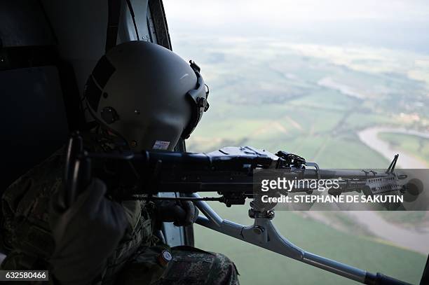 Soldier remains on a helicoper as it overflies Valle del cauca department, Colombia on January 24, 2017. French President Francois Hollande visits...
