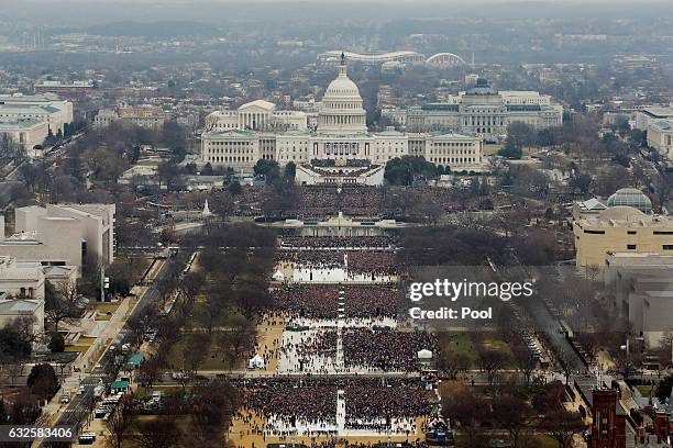 Attendees line the Mall as they watch ceremonies to swear in Donald Trump on Inauguration Day on January 20, 2017 in Washington, DC. Donald J. Trump...