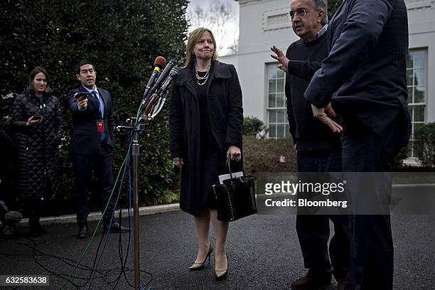 Mary Barra, chief executive officer of General Motors Co. , center, looks towards Mark Fields, president and chief executive officer of Ford Motor...