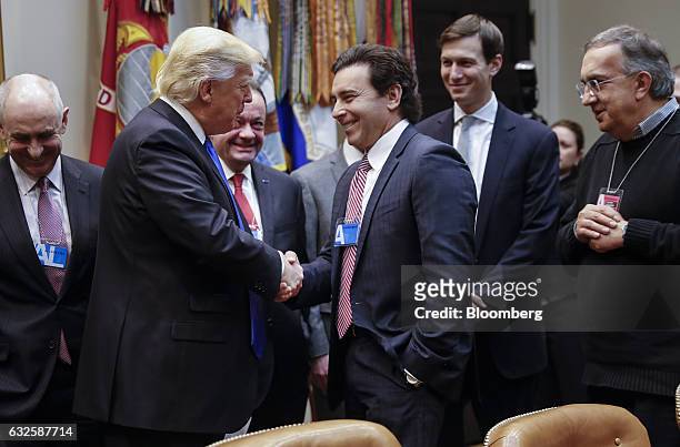 President Donald Trump, second left, shakes hands with Mark Fields, president and chief executive officer of Ford Motor Co., center, as Sergio...