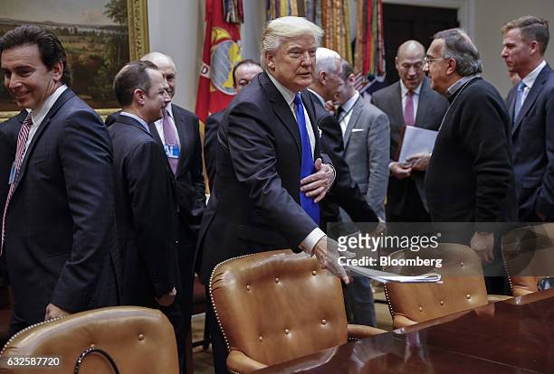 President Donald Trump, center, arrives for a meeting with Mark Fields, president and chief executive officer of Ford Motor Co., left, and Sergio...