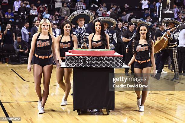 The Phoenix Suns dance team present the commissioner with a cake during the San Antonio Spurs game against the Phoenix Suns part of NBA Global Games...