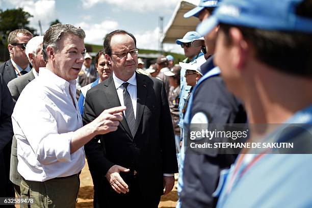 Colombian President Juan Manuel Santos and French President Francois Hollande greet United Nations delegates in Caldono, Valle del cauca department,...