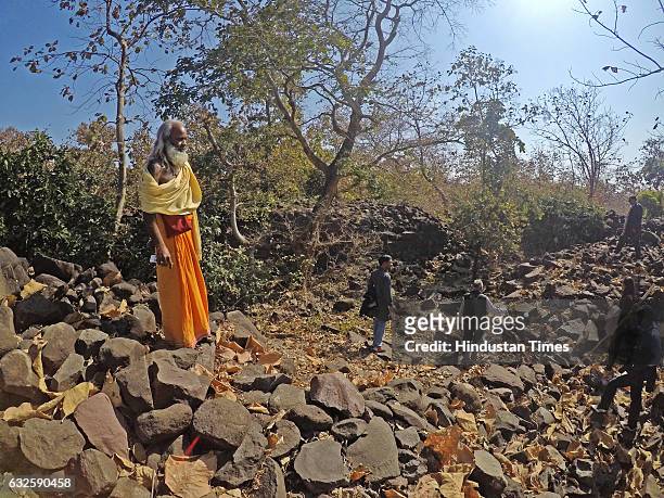 Sukhdev Maharaj poses for the photograph by standing on the Great wall of raisen in forest on January 8, 2017 in Raisen, India. History buffs are...