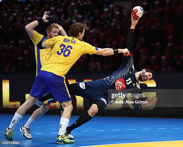 Nikola Karabatic of France challenges Jesper Neilsen of Sweden during the 25th IHF Men's World Championship 2017 Quarter Final match between France...