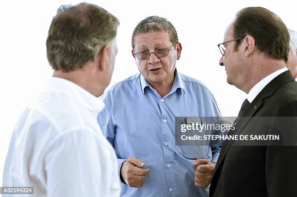 Colombian President Juan Manuel Santos and French President Francois Hollande speak with FARC member Pablo Catatumbo during a visit to a FARC rebel...