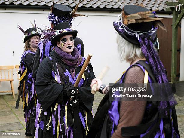 Rack-a-back Morris Men dancing a stick dance at an orchard-visiting wassail in Kilham village, Yorkshire Wolds, UK on 21st January 2017. Wassail is a...