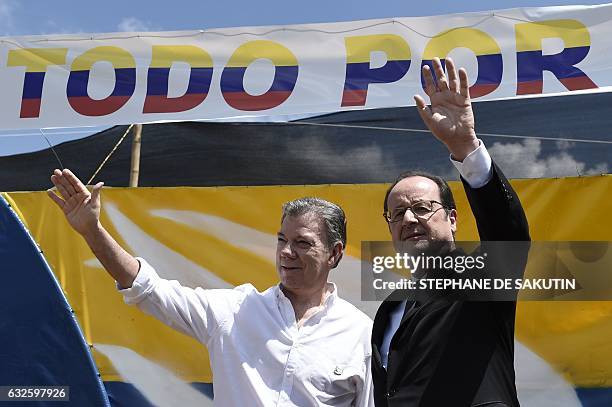 Colombian President Juan Manuel Santos and French President Francois Hollande wave in Caldono, Valle del cauca department, Colombia on January 24...