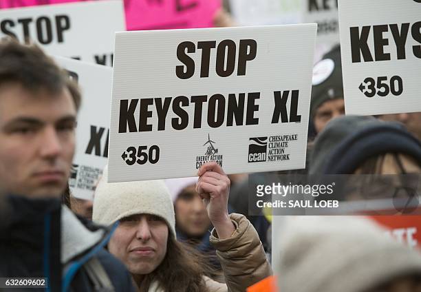 Opponents of the Keystone XL and Dakota Access pipelines hold a rally as they protest US President Donald Trump's executive orders advancing their...