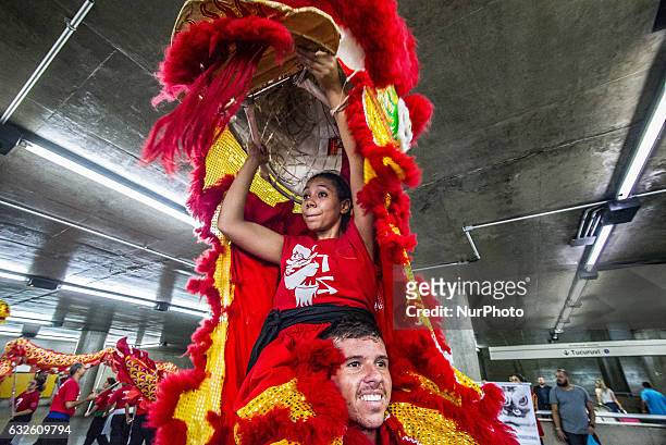 People perform dragon dance to announce Chinese Lunar New Year celebrations at Metro's Sé Station in Sao Paulo, Brazil, on January 24, 2017. The...