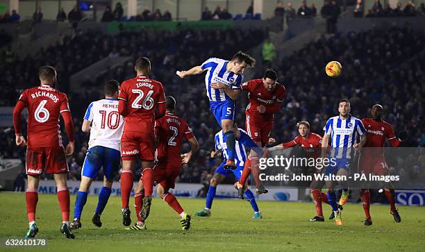 Brighton & Hove Albion's Lewis Dunk heads the ball towards goal under pressure from Cardiff City's Sean Morrison during the Sky Bet Championship game...