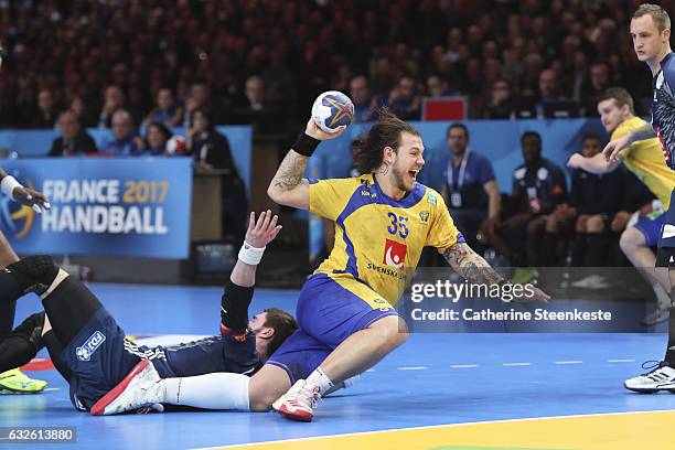 Andreas Nilsson of Sweden shoots the ball against Ludovic Fabregas of France during the 25th IHF Men's World Championship 2017 Quarter Final match...