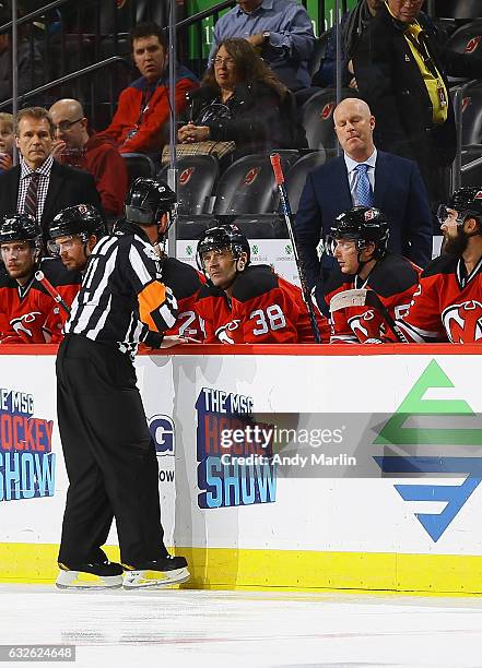 Referee Kelly Sutherland talks to New Jersey Devils Head Coach John Hynes during the second-period of the game against the Los Angeles Kings at...