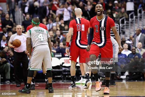 John Wall of the Washington Wizards celebrates during the closing mintues of the Wizards 123-108 win over the Boston Celtics at Verizon Center on...