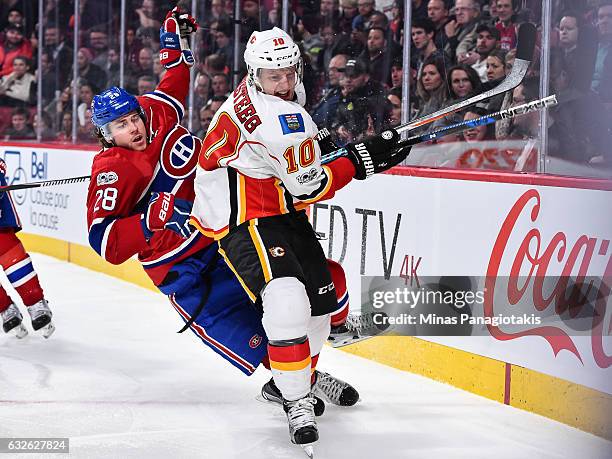 Nathan Beaulieu of the Montreal Canadiens loses his balance as he skates against Kris Versteeg of the Calgary Flames during the NHL game at the Bell...