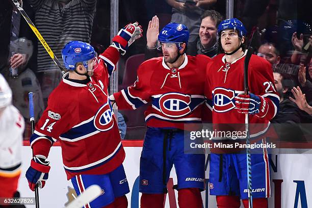 Alexander Radulov of the Montreal Canadiens celebrates his third period goal with Tomas Plekanec and Nathan Beaulieu during the NHL game against the...