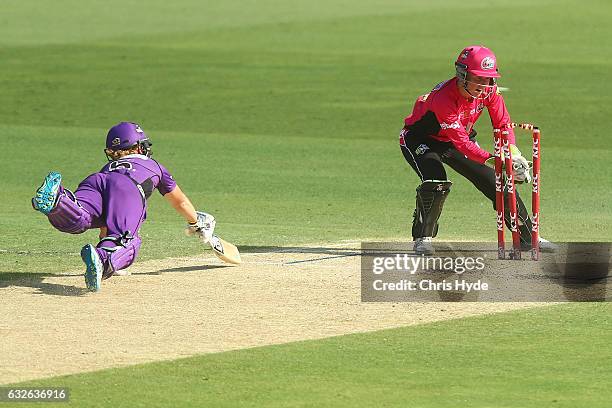 Alyssa Healy of the Sixers celebrates running out Heather Knight of the Hurricanes bats during the Women's Big Bash League semi final match between...