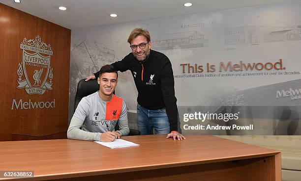 Philippe Coutinho of Liverpool signs a new contract with Jurgen Klopp manager of Liverpool at Melwood Training Ground on January 24, 2017 in...