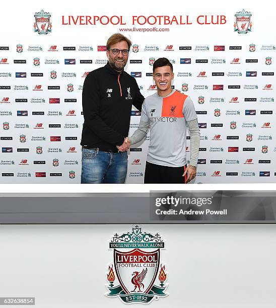 Philippe Coutinho of Liverpool poses after signing a new contract with Jurgen Klopp manager of Liverpool at Melwood Training Ground on January 24,...