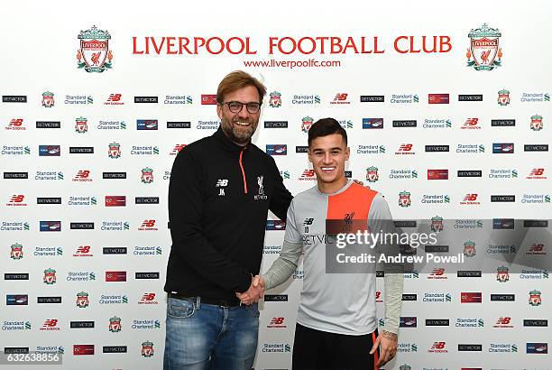 Philippe Coutinho of Liverpool poses after signing a new contract with Jurgen Klopp manager of Liverpool at Melwood Training Ground on January 24,...
