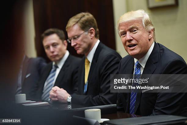 Elon Musk of SpaceX, left, and Wendell P. Weeks of Corning, center, listen to President Donald Trump during a meeting with business leaders in the...