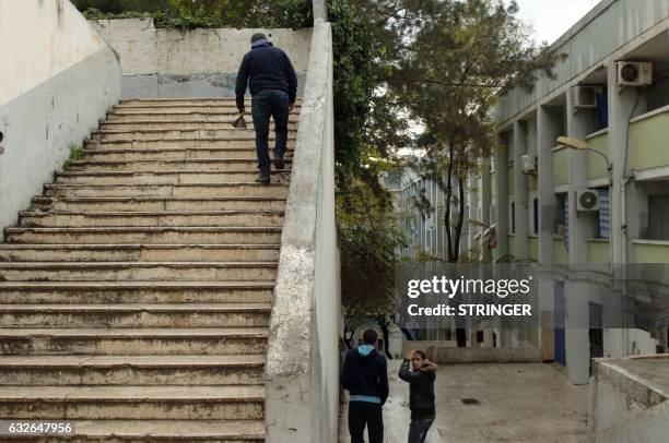 Algerians walk in Carrière-Jaubert one of the oldest suburbs on the northern outskirts of the capital Algiers, known for its gang violence, on...