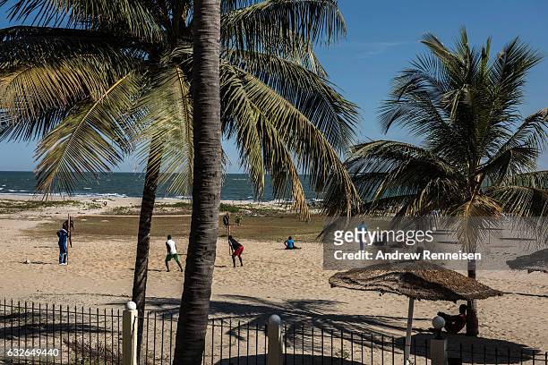 Group of people play volleyball on the almost empty beach on January 25, 2017 in Cape Point, The Gambia. Many popular travel destinations still...