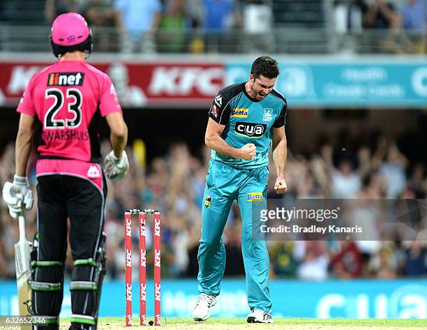 Ben Cutting of the Heat celebrates taking the wicket of Johan Botha of the Sixers during the Big Bash League semi final match between the Brisbane...
