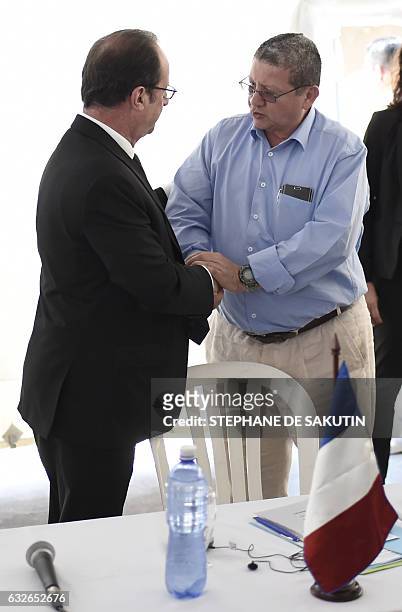 French President Francois Hollande shakes hands with FARC member Pablo Catatumbo during a visit with Colombian President to a FARC rebel disarmament...