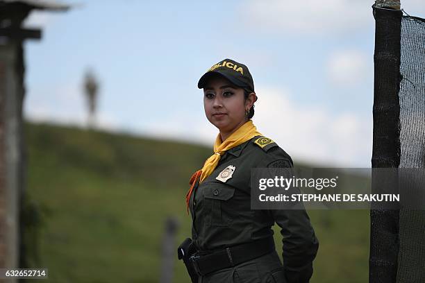 Colombian police officer stands guard during a visit of Colombian President Juan Manuel Santos and French President Francois Hollande to a FARC rebel...