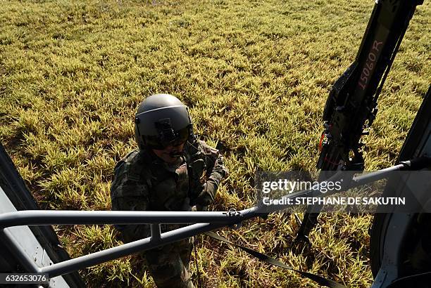 Soldier stands by an helicopter during a visit of Colombian President Juan Manuel Santos and French President Francois Hollande to a FARC rebel...