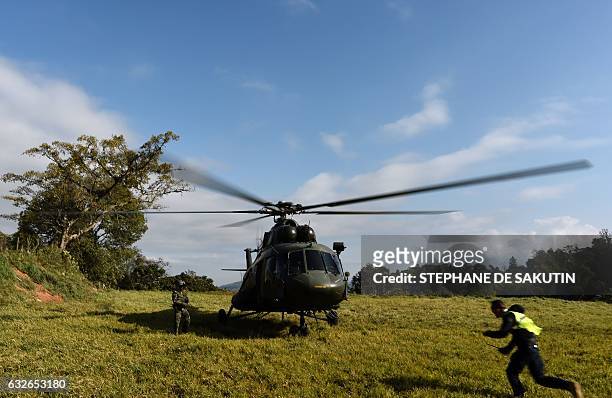 Soldier stands by an helicopter during a visit of Colombian President Juan Manuel Santos and French President Francois Hollande to a FARC rebel...