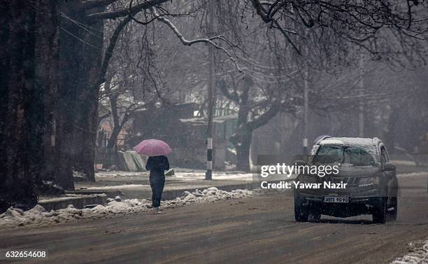 Commuter walks during a heavy snowfall on January 25, 2017 In Srinagar, the summer capital of Indian administered Kashmir, India. An Indian army...