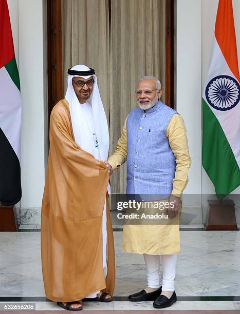 The Crown Prince of Abu Dhabi General Sheikh Mohammed Bin Zayed Al Nahyan shakes hands with Indian Prime Minister Narendra Modi ahead of a meeting at...