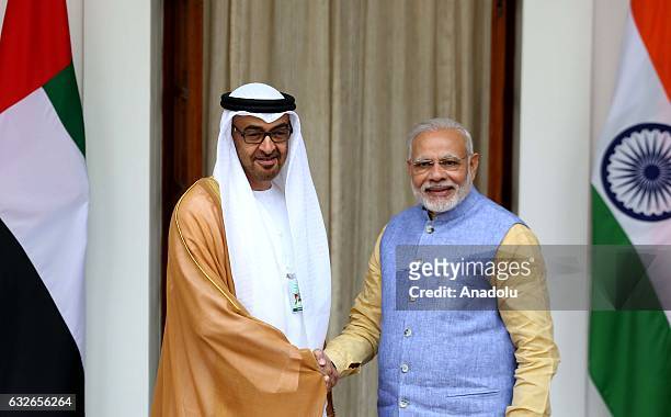 The Crown Prince of Abu Dhabi General Sheikh Mohammed Bin Zayed Al Nahyan shakes hands with Indian Prime Minister Narendra Modi ahead of a meeting at...