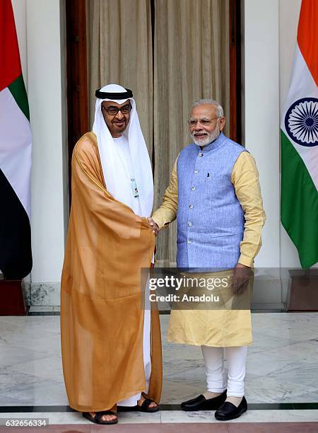 The Crown Prince of Abu Dhabi General Sheikh Mohammed Bin Zayed Al Nahyan shakes hands with Indian Prime Minister Narendra Modi ahead of a meeting at...