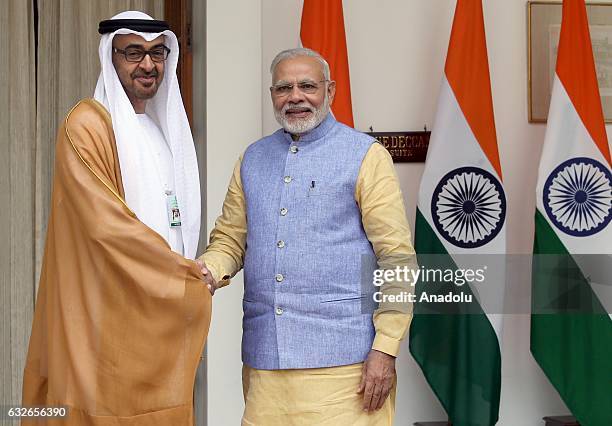 The Crown Prince of Abu Dhabi General Sheikh Mohammed Bin Zayed Al Nahyan shakes hands with Indian Prime Minister Narendra Modi ahead of a meeting at...