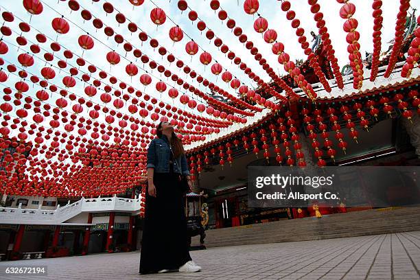 An ethnic Chinese girl looks at the lanterns at the Thean Hou temple ahead of the Lunar New Year of the Rooster celebrations on January 25, 2017 in...