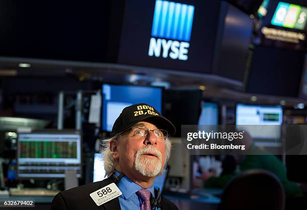 Trader wearing a "DOW 20,000" hat works on the floor of the New York Stock Exchange in New York, U.S., on Wednesday, Jan. 25, 2017. The Dow Jones...